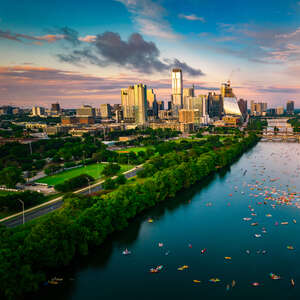 A colorful skyline at golden hour blue and pink clouds over Austin Texas USA Aerial Drone view above cityscape.